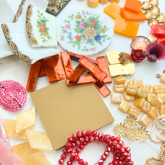 A mix of porcelain china, beads, glass, smalti, ceramic, brass, metal and whimsical mosaic materials.