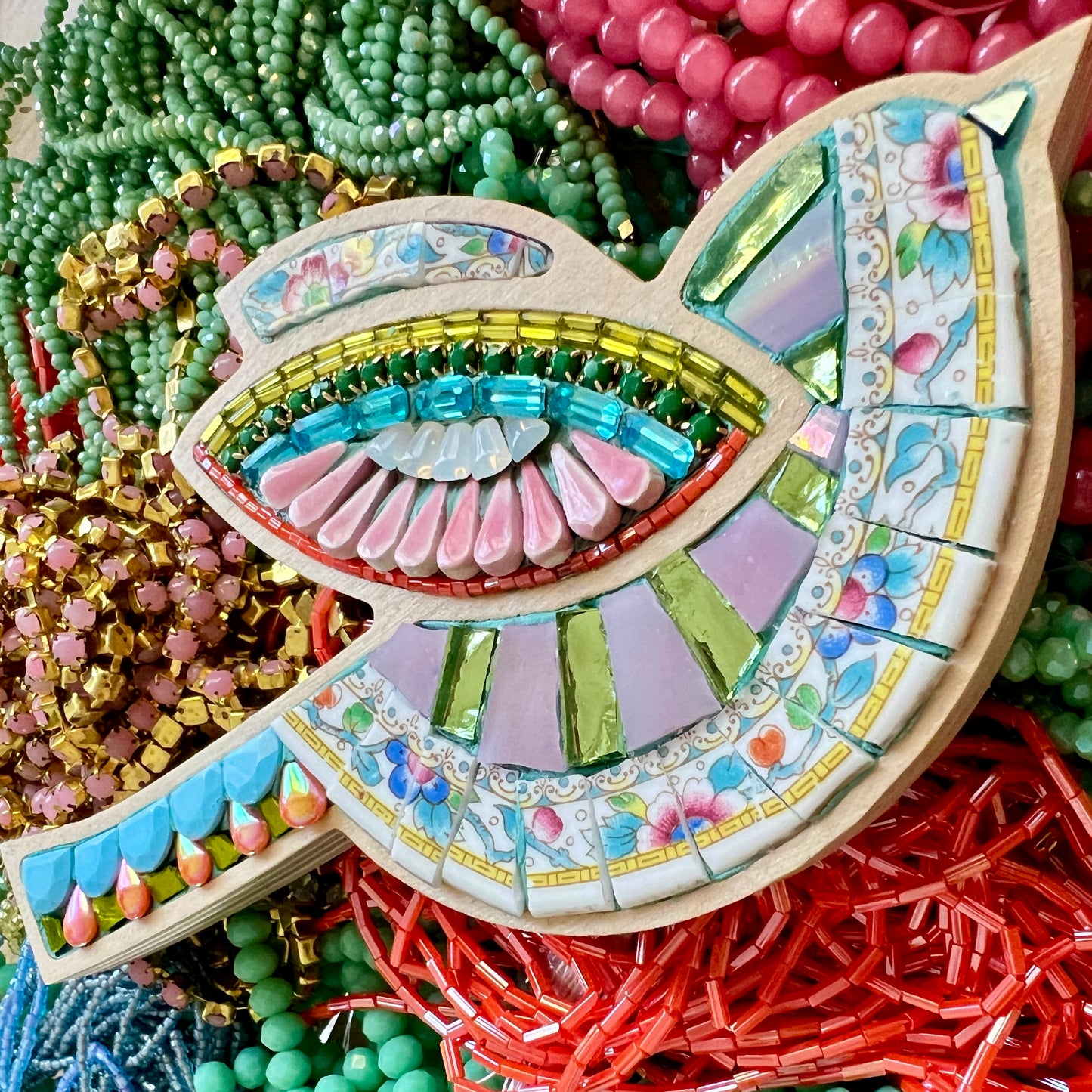 Sharra Frank teaching a mosaic class with colorful tiles, beads, and fine china pieces.