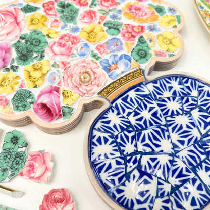 A charming floral mosaic using a curated collection of vintage china patterns set inside a custom bouquet-in-a-vase wooden frame.