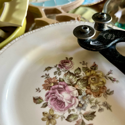 Porcelain china plate and mosaic wheeled nipper tool.