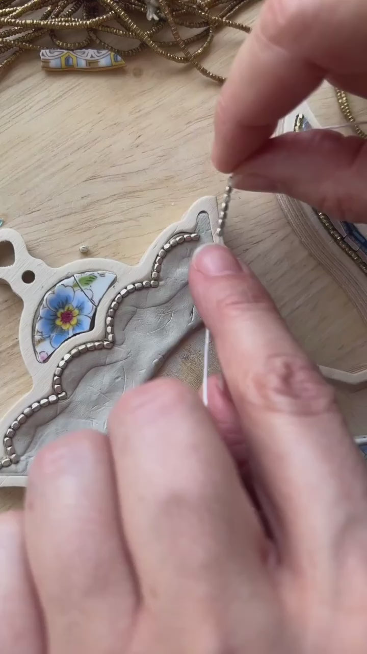 Mosaic Artist Sharra Frank making a teapot mosaic with beads, china and glass.