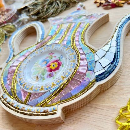 Mosaic Art by Sharra Frank, a mosaic teapot in a wood frame made with porcelain china, beads and glass.